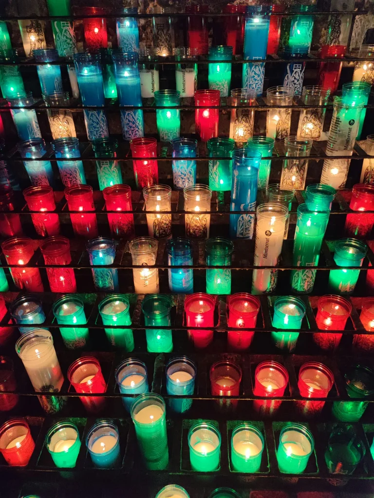 Rows of lit votive candles